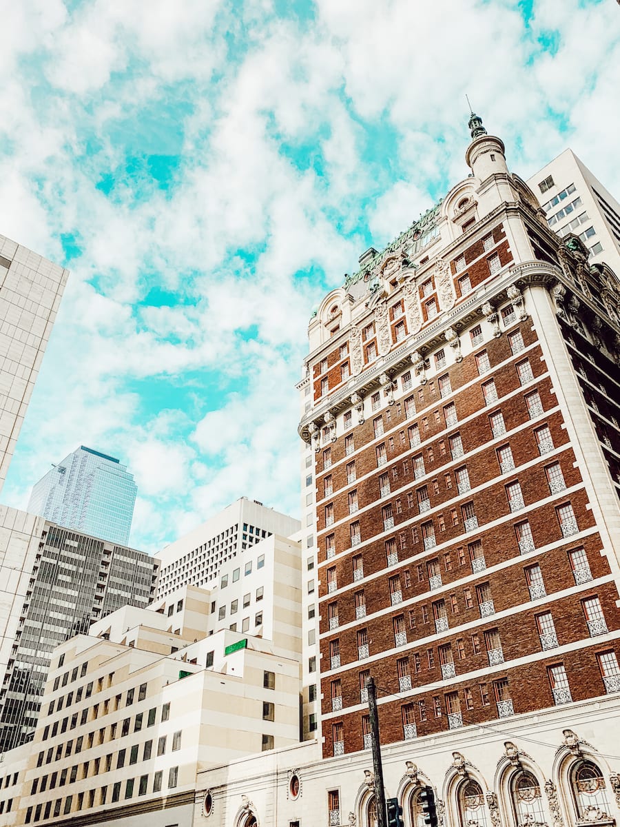 view of Adolphus hotel outside looking up at skyline